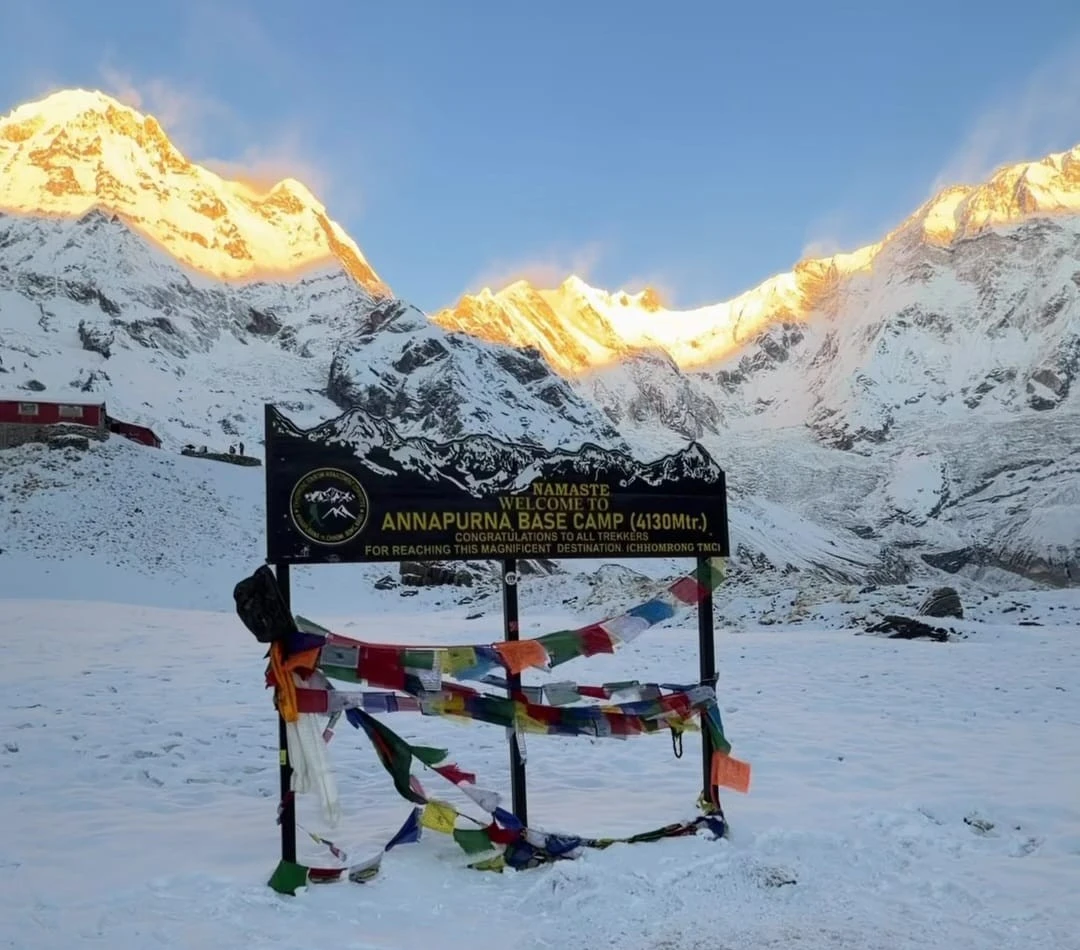 Photograph of the Annapurna Base Camp welcome board taken during the Annapurna Sanctuary Trek, showcasing the scenic Himalayan surroundings