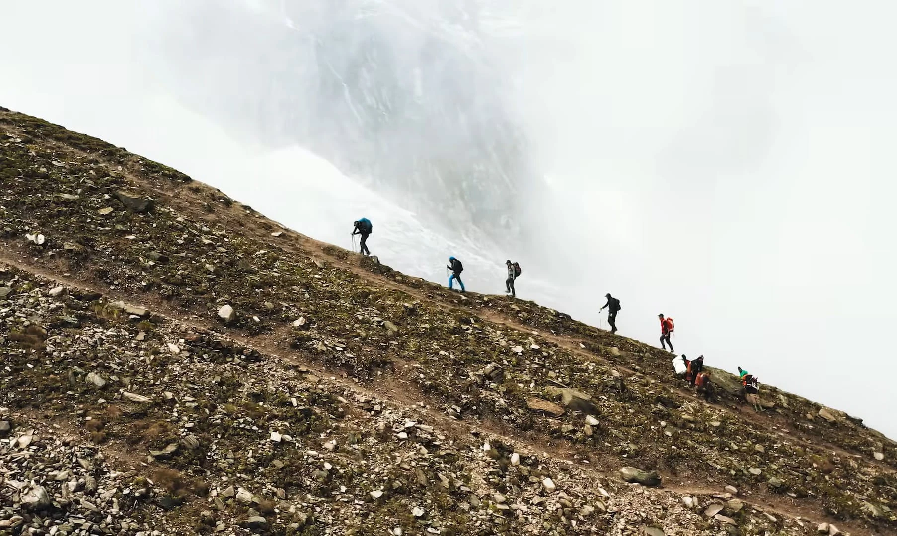 Climbers ascending the steep rocky sections of Kusum Kanguru peak in Nepal